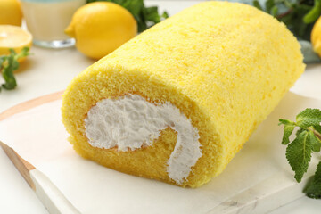 Delicious cake roll and mint on table, closeup