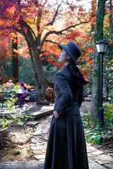The girl and the old maple tree in the mountains