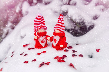 Christmas toys stand on the branches of a snow-covered fir tree
