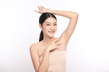 Obraz premium Beautiful Young Asian woman lifting hands up to show off clean and hygienic armpits or underarms on white background, Smooth armpit cleanliness and protection concept