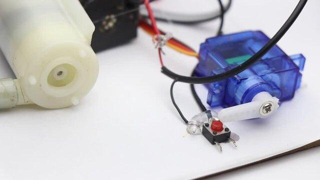 Micro servo activating the toggle switch with its horns. Servo used as a switch to turn on and off other electronic components like small pump