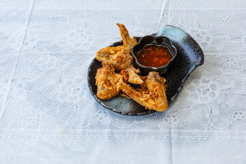 Drummer chicken wing with Fish Sauce on a white plate, less oil frying, and crispy