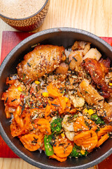 top view Korean chicken bibimbap with cup of coffee at vertical composition