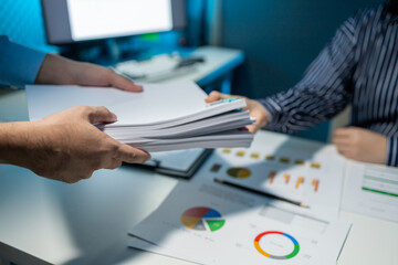 Hand a pile of important documents to a co-worker, Forward a summary of the previous month's meeting agenda to the department head, Big stack of documents