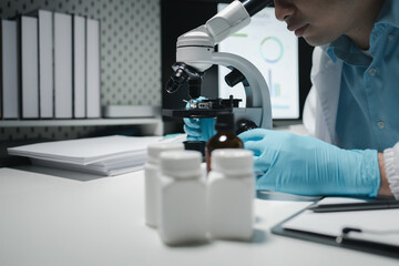 scientist working in the laboratory, scientists conducting research investigations in a medical laboratory, a researcher in the foreground is using a microscope,