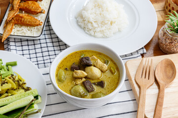 Thai food chicken green curry on old wooden background, Top view. Thai Street Food