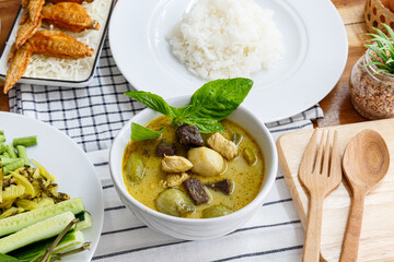 Thai food chicken green curry on old wooden background, Top view. Thai Street Food