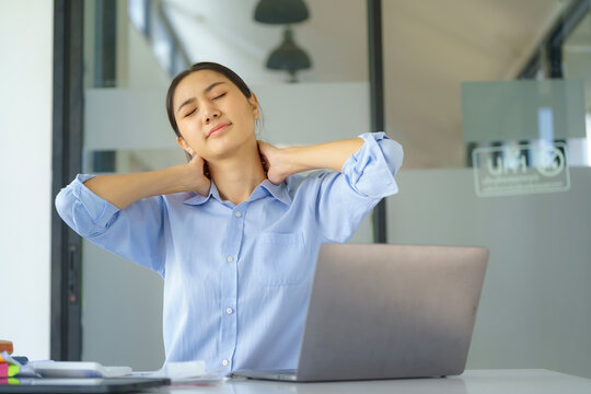 Businesswoman working in an office stretches to relax from work during breaks.