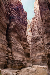 A small  shallow stream flows along hiking trail in the Wadi Numeira gorge in Jordan
