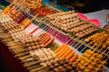 Skewers of streetfood on a table in Thailand,Steamed hot dogs
