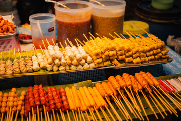 Skewers of streetfood on a table in Thailand,Steamed hot dogs