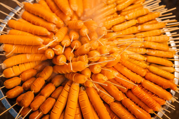 Skewers of streetfood on a table in Thailand,Steamed hot dogs