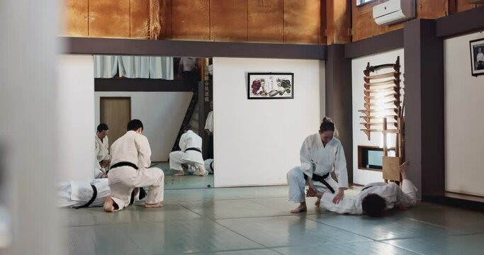 Students, karate or people learning in dojo for fitness, martial arts discipline or self defense combat. Demonstration, workout or kung fu master training athletes for fighting, education or class