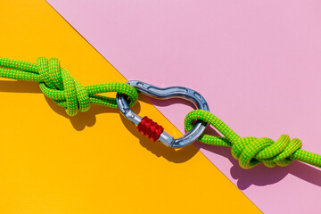 two ropes with secure knots are connected by a carabiner. Equipment for rock climbing and...