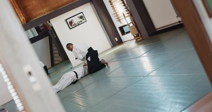 Students, karate or man teaching martial arts in dojo for fitness, discipline or self defense for combat Demonstration, workout or kung fu master training a person for fighting, education or class
