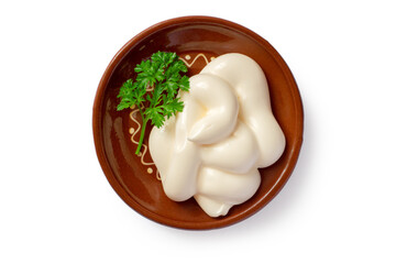 Mayonnaise with parsley in a plate on a white background. Top view. Ceramic plate with mayonnaise.