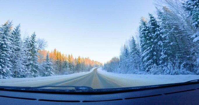 Enchanting Winter Drive. Forest Road POV Exploration. Magic of winter unfold POV video featuring a car driving. Beautiful forest road. Super Wide Field view against the winter scenery, enhanced by cin