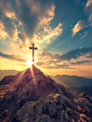 Christian cross at the top of hill with morning sun rays shining behind