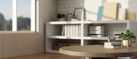 Close-up image of an empty space on a wooden round table in a modern room with a bookcase.