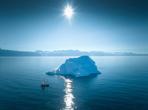 Arctic Adventure: Sailing Amidst Greenland's Glaciers on a Sunlit Day - Aerial Drone View