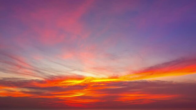 aerial hyperlapse view The bright light illuminated the clouds drifting in the sky. 
Magical clouds formed spirals in colorful sunset.
colorful clouds spinning around in a mesmerizing dance.