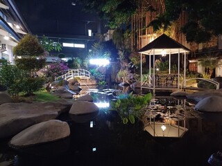 Garden decoration with fish ponds, rocks, gazebo, bridges and artificial waterfalls