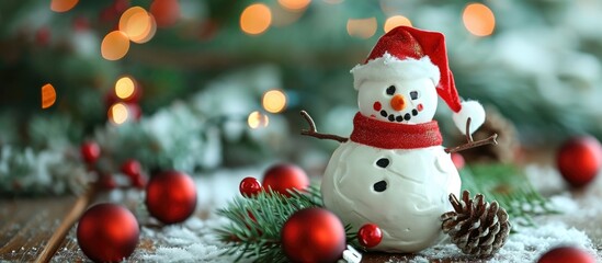 Fototapeta premium DIY Christmas decoration: snowman adorned with red ornaments