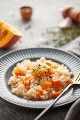 Pumpkin risotto with fresh thyme in plate. Italian Food