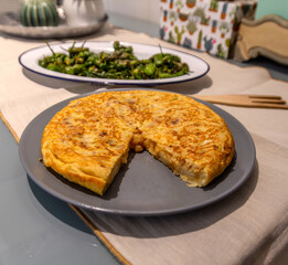 Spanish omelette with Padrón peppers. Selective focus. Galicia.