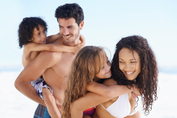 Obraz premium Happy family, beach and piggyback for bonding, vacation or outdoor holiday weekend together. Father, mother and children smile for hug, love or back ride on summer break by the ocean coast in nature