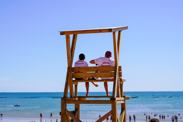 nageur sauveteur french text on shirt means man woman work  lifeguard in wooden tower on the summer sandy beach