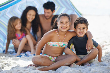 Girl, boy with family on beach and smile in portrait, summer vacation with hug, bonding and love. People outdoor, holiday in Brazil with sand and sun, children happy for travel and adventure together