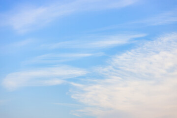 A beautiful sky tinted by the sun leaving vibrant shades of gold, pink, blue and multicolored. Clouds in the twilight evening and morning sky. Cloudy sky background in the evening and during the day.