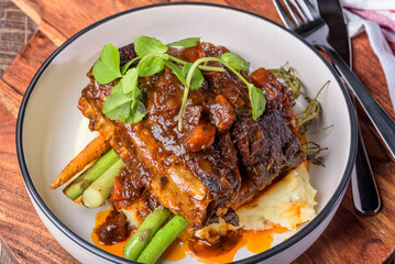 Red wine braised short ribs with grilled carrot and green vegetables