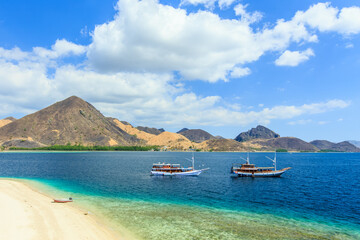 Fototapeta na wymiar Panorama view of beaches and tourist boat sailing in Kelor Island, Flores Island, Indonesia