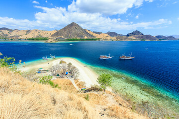 Panorama view of beaches and tourist boat sailing in Kelor Island, Flores Island, Indonesia