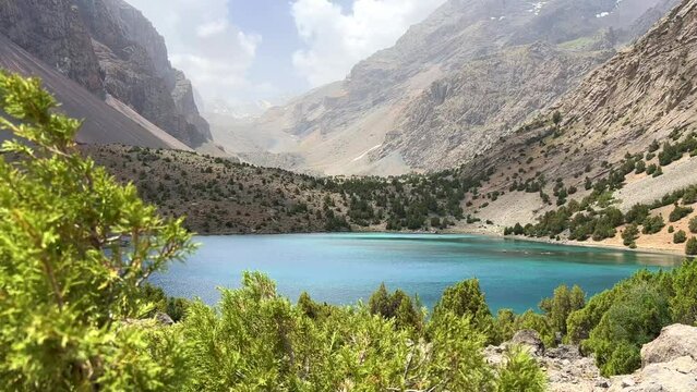 The Alaudin (Chapdara) lakes, lying at an altitude of 2800 m, are considered one of the most beautiful lakes of the Fan Mountains. Turquoise mountain lake. Pamiro-Alai. Tajikistan, Pamir 4K