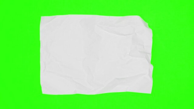 Blank sheet of white paper appears on green screen chroma key background from a paper ball, wrinkles again and disappears. Stop motion animation. 