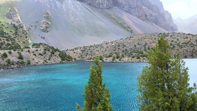 The Alaudin (Chapdara) lakes, lying at an altitude of 2800 m, are considered one of the most beautiful lakes of the Fan Mountains. Turquoise mountain lake. Pamiro-Alai. Tajikistan, Pamir 4K