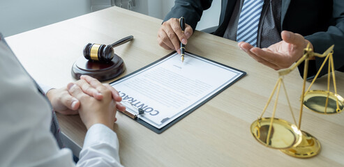 Lawyer hand holding pen and providing legal consult business dispute service at the office with...