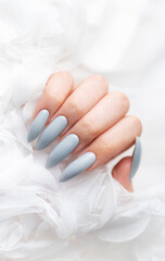 Grey nails on white lace background.