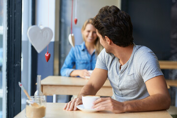 Back, flirting or happy man in cafe with a coffee to relax with smile, morning espresso or crush. Face, romance or person looking with tea, cappuccino or woman with love, peace or calm in restaurant - obrazy, fototapety, plakaty