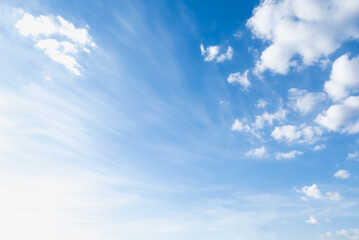 Fototapeta premium Blue sky with some clouds. View over the clouds light background