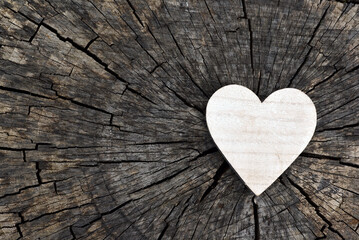 Holiday card for Valentines day. Heart on old wood.