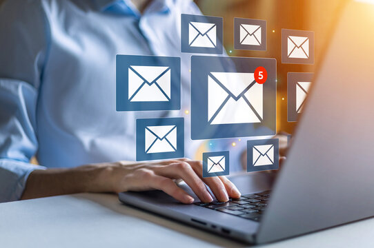 Businesswoman using laptop with email notification alert on virtual screen. Receiving e-mail for business. Human resources and management concept. 