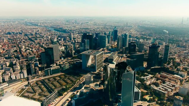 Establishing Aerial view of Business District in Paris Downtown with Skyscrapers, Office Buildings and Grande Arche de la Defense. Modern Cityscape of Capital of France. 4K drone zoom out shot