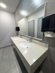 White washbasin with tap in the restroom