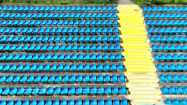 Empty plastic blue seats on football, soccer stadium