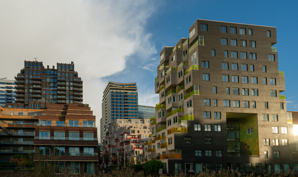 Modern apartment buildings in ZuidAs in Amsterdam, with older office buildings in background in The Netherlands.