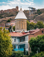View on the Narikala fortress wall, the Tbilisi ropeway and the blue roof of the bell tower of Siono Cathedral in Kala, Tbilisi old town, Georgia - obrazy, fototapety, plakaty